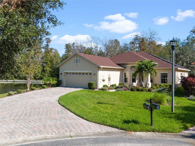 view of front of home featuring a front lawn and a garage