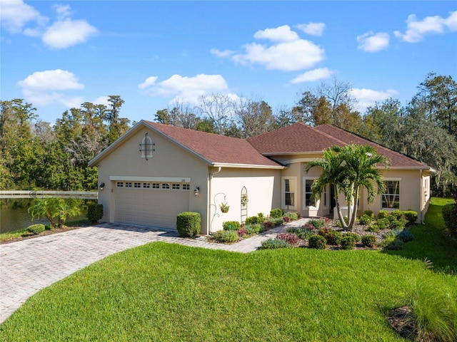 view of front of property with a front lawn and a garage