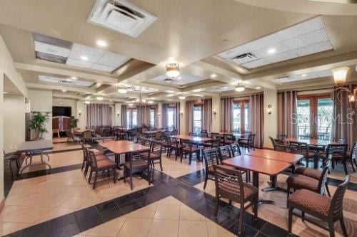 dining space with tile patterned flooring, french doors, and coffered ceiling