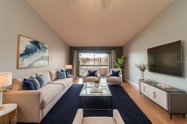 living room with light hardwood / wood-style flooring and lofted ceiling