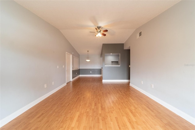 unfurnished living room with light wood-type flooring, ceiling fan, and vaulted ceiling