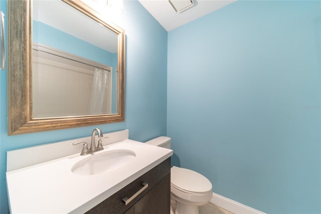 bathroom with toilet and vanity