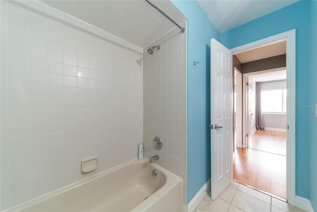 bathroom with hardwood / wood-style floors and tiled shower / bath combo