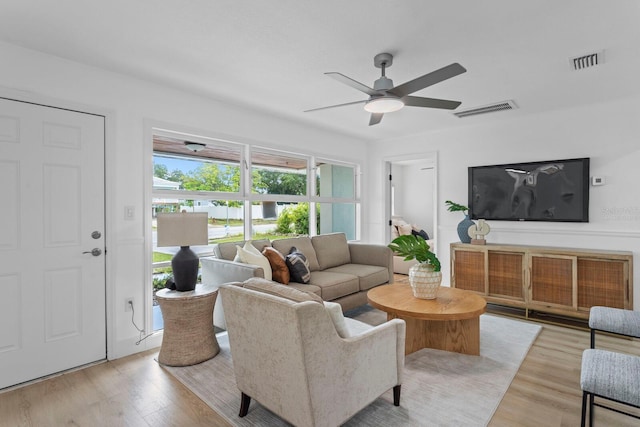 living room featuring ceiling fan and light wood-type flooring