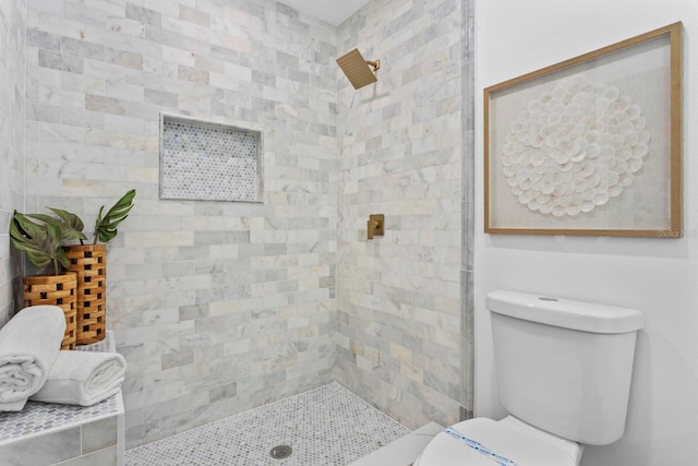 bathroom with toilet and tiled shower