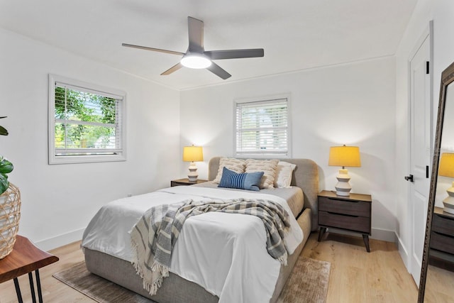 bedroom with light hardwood / wood-style flooring and ceiling fan