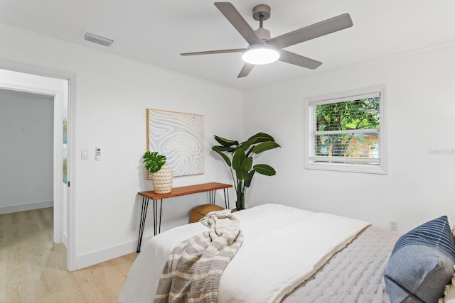 bedroom with light hardwood / wood-style floors and ceiling fan