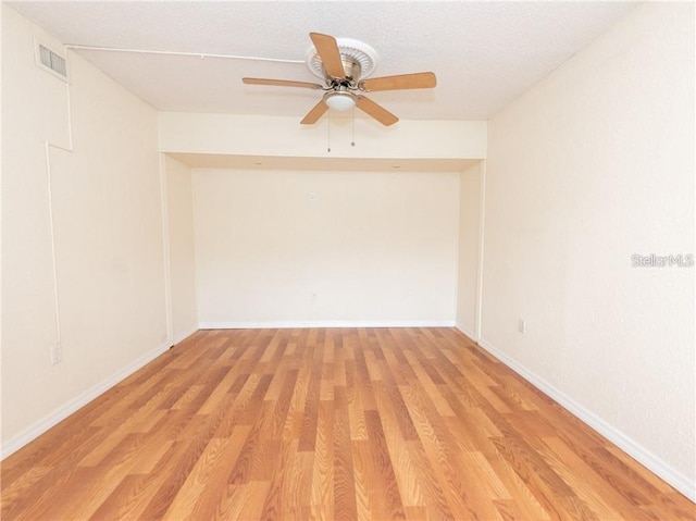 spare room featuring light wood-type flooring and ceiling fan