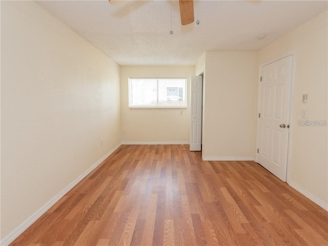 spare room with ceiling fan and light hardwood / wood-style flooring