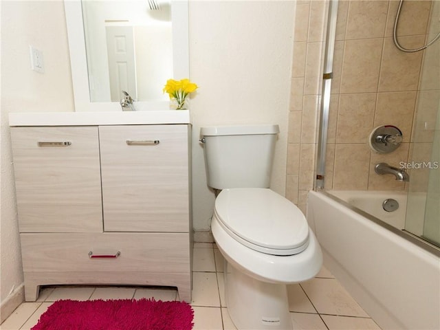 full bathroom with toilet, vanity, tiled shower / bath, and tile patterned flooring