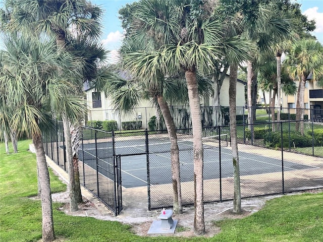 view of tennis court with a lawn