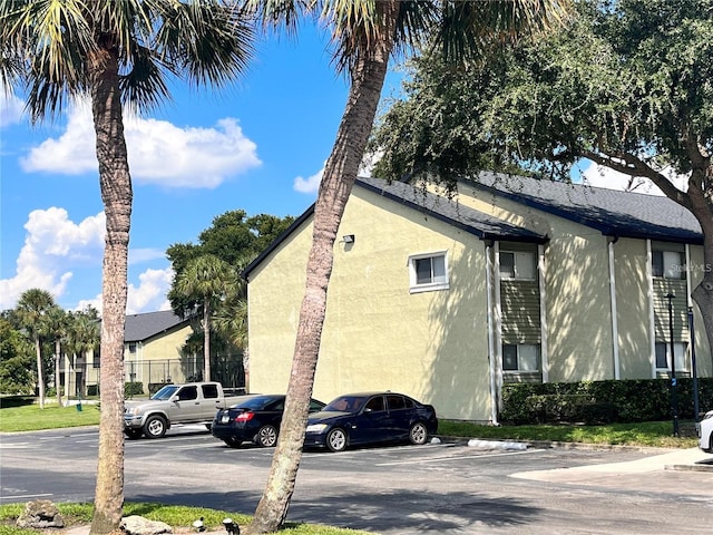 934 Lake Destiny Rd Unit D, Altamonte Springs, FL 32714 - view of side of property with uncovered parking and stucco siding
