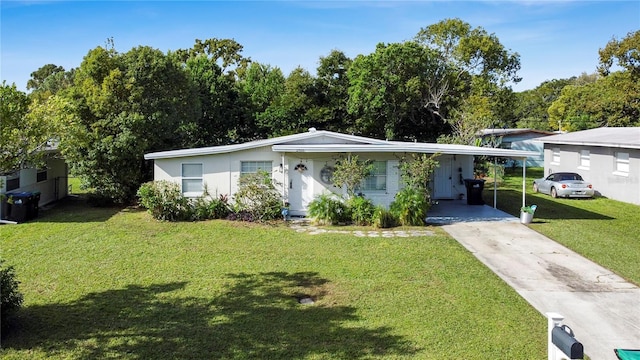 ranch-style house featuring a front lawn and a carport
