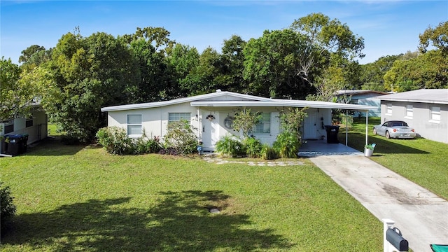 ranch-style house featuring a front lawn and a carport