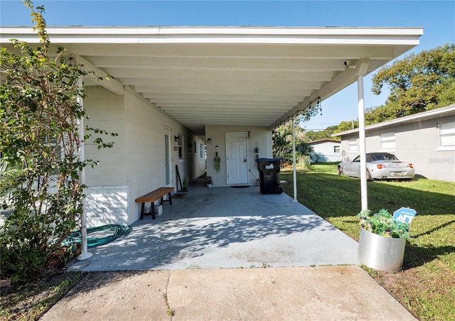 view of car parking featuring a lawn and a carport