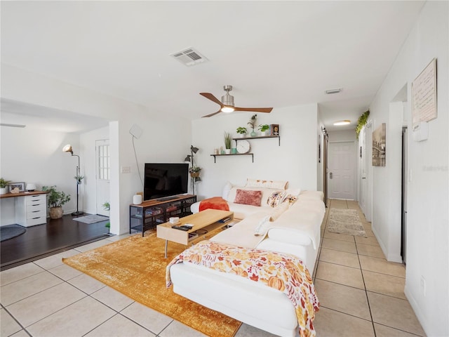 living room featuring ceiling fan and light tile patterned floors