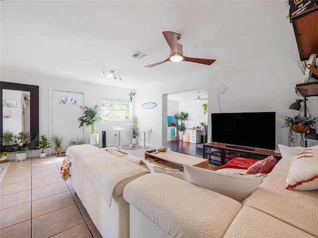 living room with ceiling fan and light tile patterned flooring