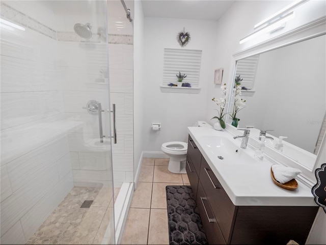 bathroom with tile patterned flooring, vanity, an enclosed shower, and toilet