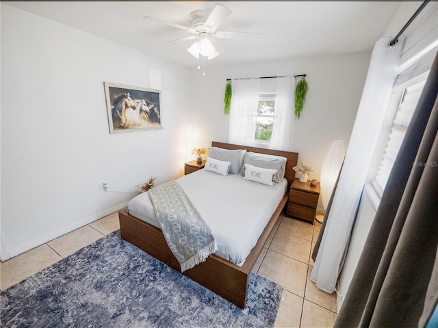 bedroom with ceiling fan and light tile patterned floors