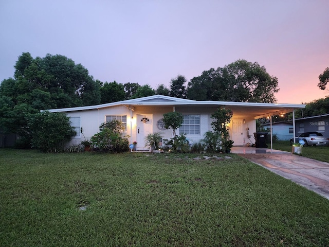 single story home featuring a yard and a carport