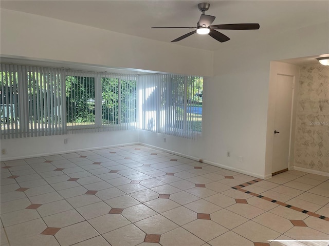 spare room featuring light tile patterned flooring and ceiling fan