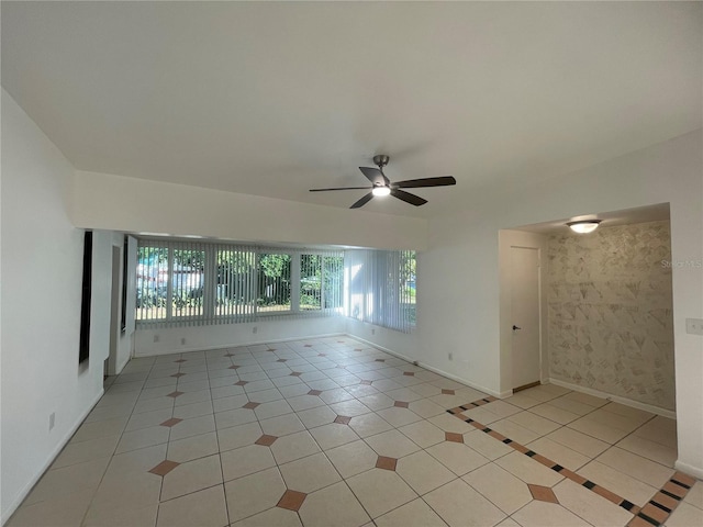 tiled empty room featuring ceiling fan