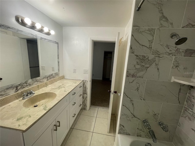 bathroom with vanity, tile patterned flooring, and tiled shower / bath