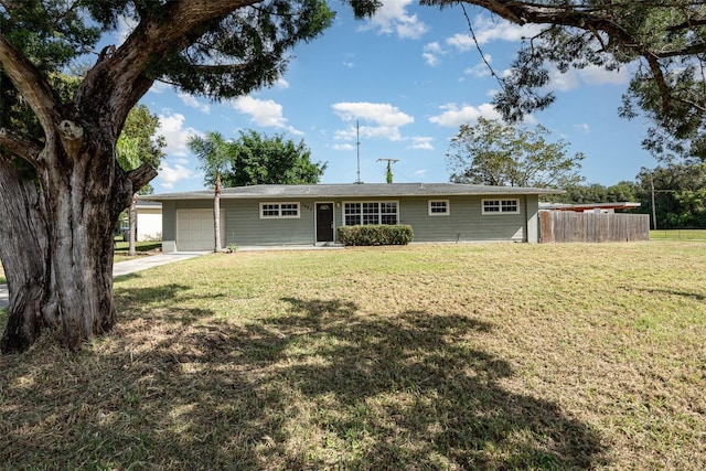 ranch-style house with a garage and a front yard