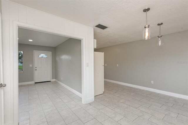 entrance foyer with a textured ceiling