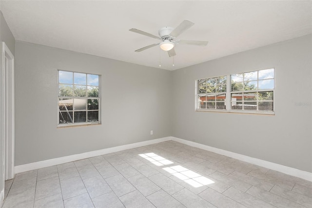 tiled empty room with ceiling fan