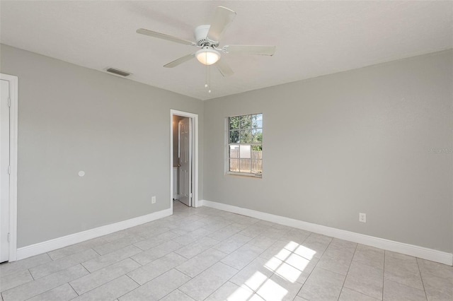 spare room featuring light tile patterned floors and ceiling fan