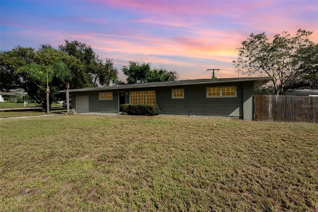 ranch-style home featuring a yard