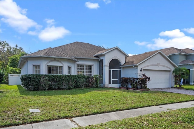 ranch-style house with a garage and a front yard