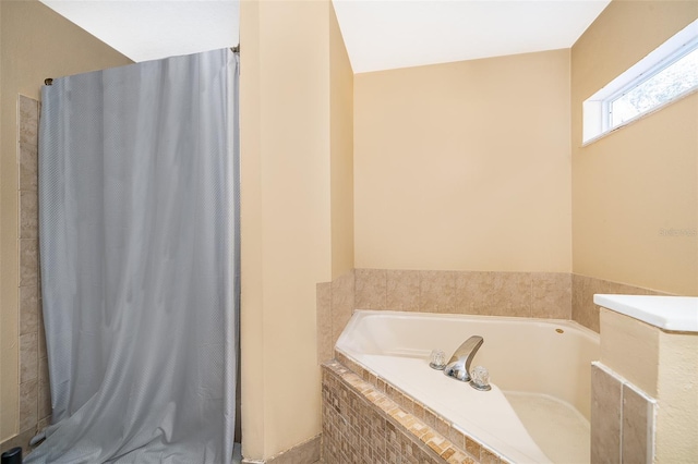 bathroom with tiled tub