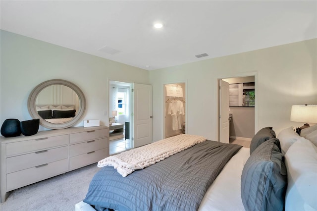 carpeted bedroom featuring ensuite bath