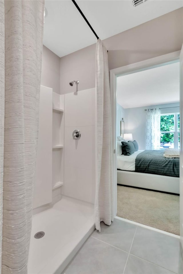 bathroom featuring walk in shower and tile patterned floors