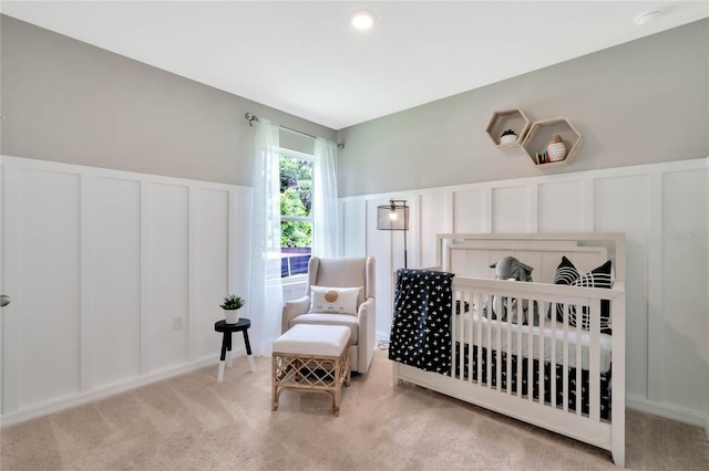 carpeted bedroom featuring a crib