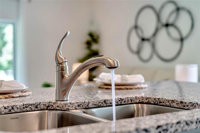 room details featuring sink and stone counters