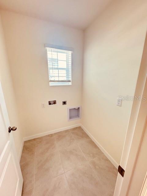 washroom with laundry area, washer hookup, electric dryer hookup, and baseboards