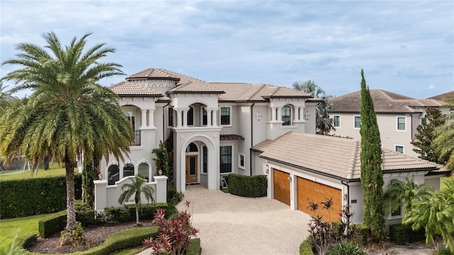 mediterranean / spanish house featuring a garage