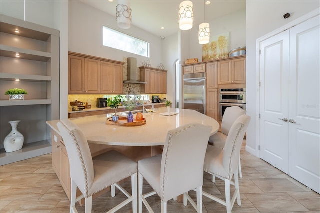 tiled dining room with built in shelves and a towering ceiling