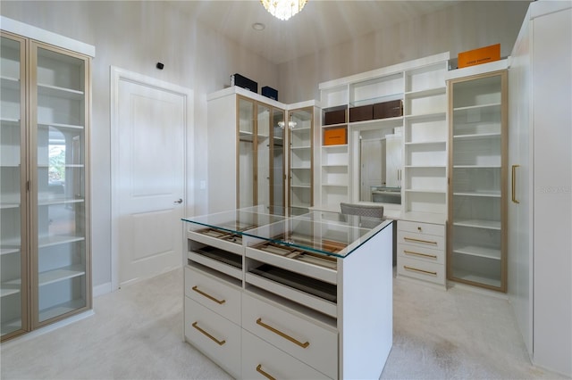 walk in closet with light colored carpet