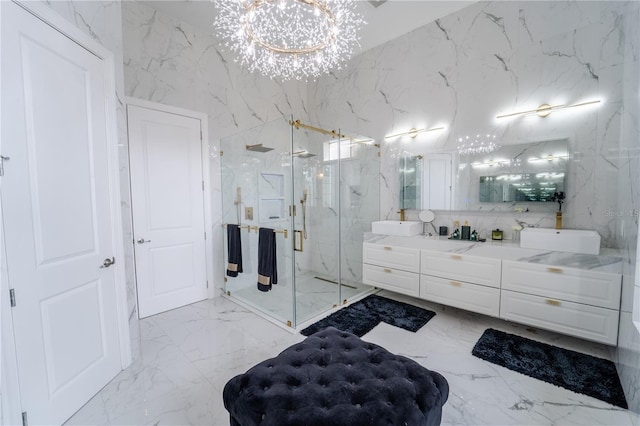 bathroom featuring vanity, a shower with shower door, and an inviting chandelier