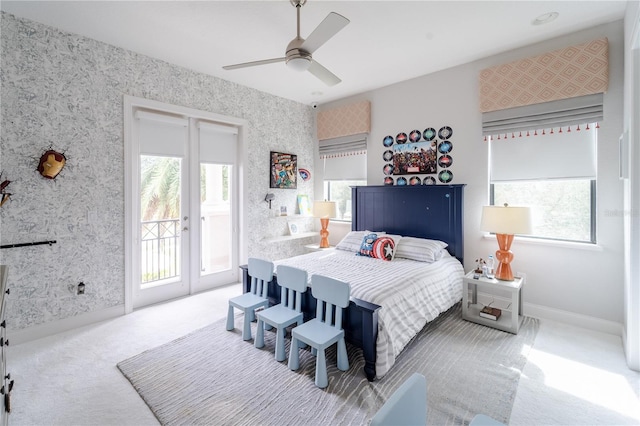 bedroom with ceiling fan, light colored carpet, access to outside, and french doors