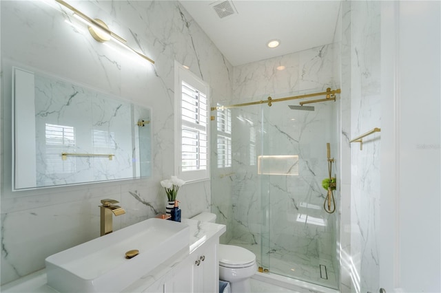 bathroom featuring vanity, toilet, and a shower with door