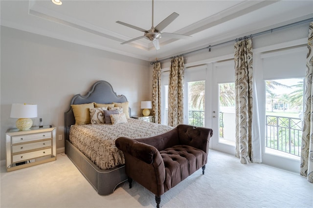 carpeted bedroom with access to exterior, a raised ceiling, ceiling fan, and ornamental molding