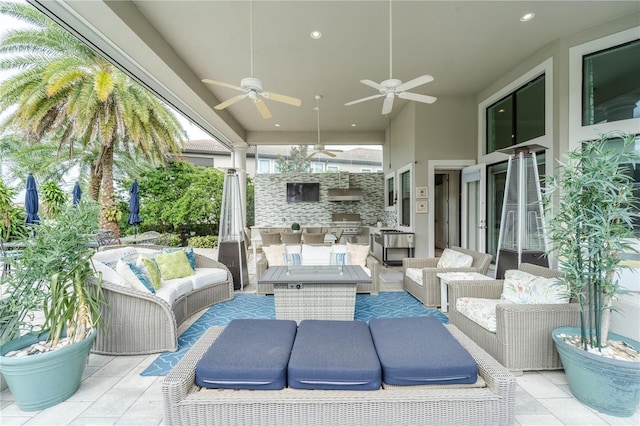 view of patio featuring ceiling fan, an outdoor kitchen, and an outdoor hangout area