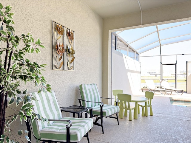 view of patio featuring glass enclosure and a swimming pool