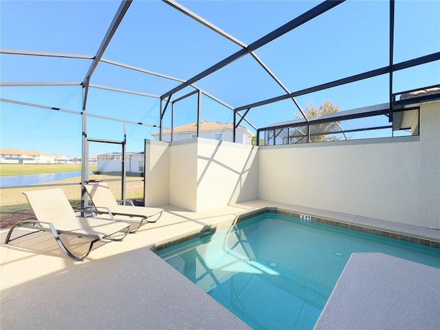 view of pool with a water view, glass enclosure, and a patio area