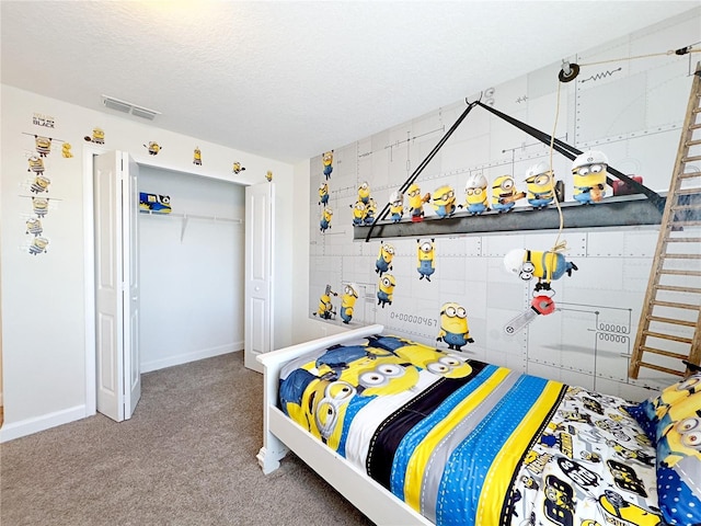 bedroom with carpet and a textured ceiling